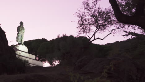 Right-panning-shot-revealing-the-statue-Grotte-Napoleon-at-sunset,-located-in-the-city-of-Ajaccio-in-Corsica,-France