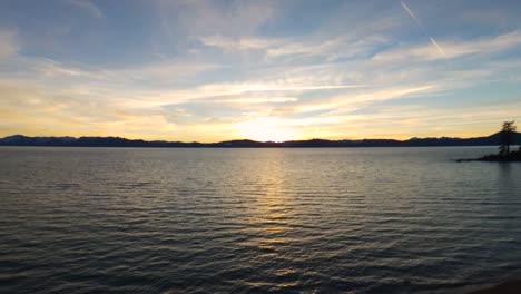 Panoramic-aerial-shot-of-sunset-by-the-beach