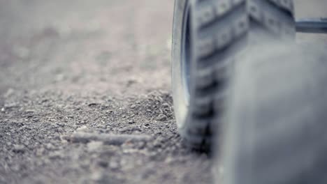 Tight-shot-of-RC-Car-peeling-out-in-gravel-and-going-away-from-the-camera