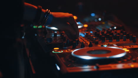 Close-up-of-a-turntable-at-a-party-with-two-dj's