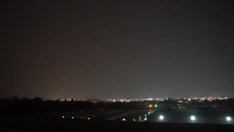 Extreme-heat-lightning-and-rain-storm-climate-weather-lights-up-industrial-buildings-at-night