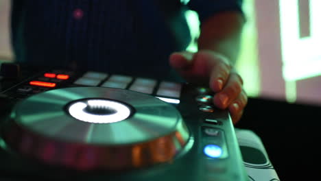 Close-Up-of-DJ-Hands-Playing-Music-on-Mixing-Turntable-During-Party,-Detail-Pan-Right