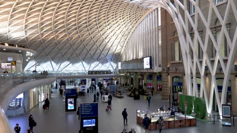 Mezzanine-View-Of-Travellers-Walking-Across-Kings-Cross-Train-Station-Concourse-On-1st-March-2022