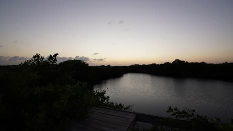 Amazing-and-colorful-timelapse-of-a-sunset-in-Nativus-Cenote-at-Tulum,-Mexico