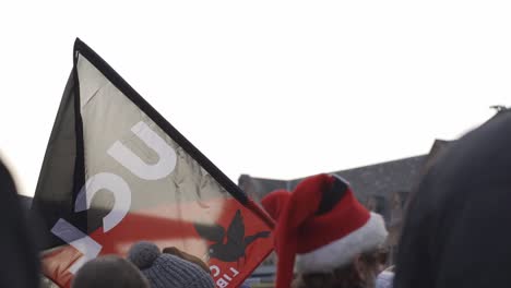 Men-with-Christmas-hat-is-waving-a-flag-in-demonstration