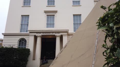 Entrance-with-girl-sitting-on-step-tent-in-foreground-camera-pans-downs