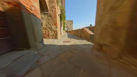 Alley-with-rustic-stone-walls-in-Tuscany,-Italy