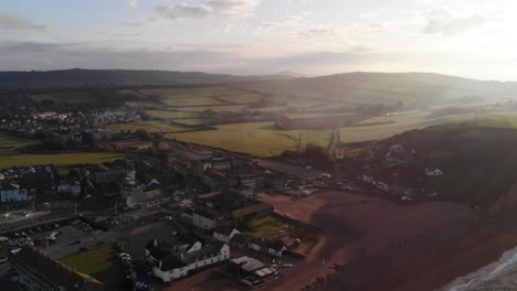 Backwards-aerial-early-morning-shot-of-the-cliffs-at-West-Bay-Dorset-England-UK