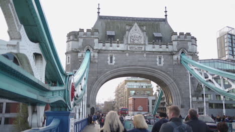 People-Passing-Tower-Bridge-Gate-on-Cold-Winter-Day,-London,-England,-UK,-Slow-Motion