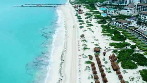 people-walking,-small-car-passing-along-the-Mexico-coastal-beach-during-the-day