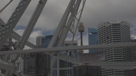 Sydney-skyline-and-Sydney-eye-Westfield-tower-view-through-a-Ferris-wheel-motion-view-in-4k