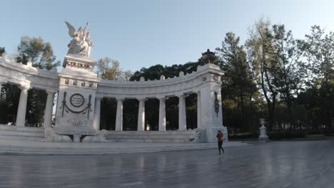 Police-officers-on-street-near-Central-Statue-at-Park-in-Mexico-DF,-pan-left