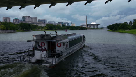 Aerial-view-around-a-tour-ferry-moving-along-the-Putrajaya-Lake-in-Malaysia