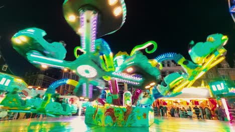 Colourful-spinning-ride-at-a-funfair-in-Haarlem-in-the-evening-with-lots-of-people-and-children-around