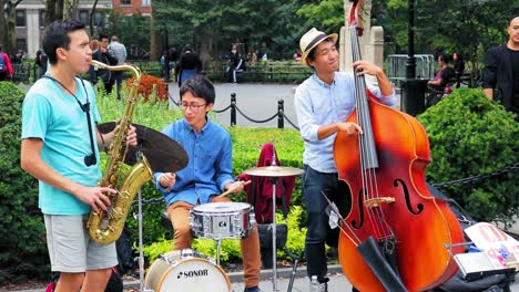 Musicians-in-Washington-Square-Park,-little-girl-dancing