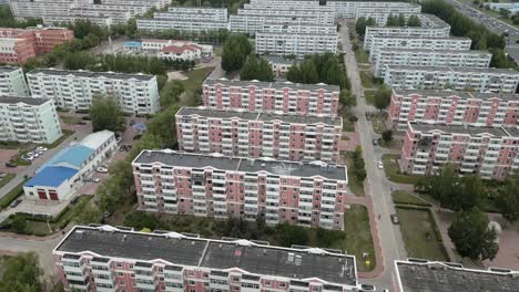 Aerial-footage-of-rows-of-red-and-blue-residential-buildings-in-Daqing,-Heilongjiang-District-in-China