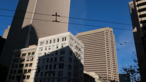 Towers-and-Office-Buildings-in-Downtown-San-Francisco,-California-USA,-View-From-Moving-Car-on-Market-Street