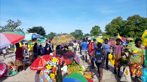 Crowds-of-people-at-the-local-fruit-and-vegetable-market-with-lots-of-colourful-umbrellas-on-the-remote-tropical-island-of-Autonomous-Region-of-Bougainville,-Papua-New-Guinea