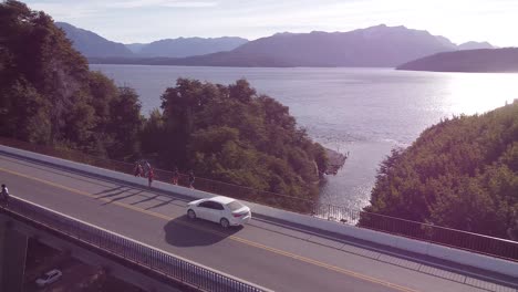 Flying-over-bridge-over-Correntoso-river-in-the-lake-of-Nahuel-Huapi-next-to-Villa-La-Angostura,-Patagonia-Argentina