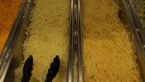 Selection-of-Shredded-Cheese-in-Buffet-Restaurant,-Close-Up