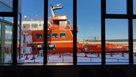 Looking-At-Docked-Garinko-II-Drift-Ice-Cruise-Ship-In-Hokkaido-Through-Large-Windows-At-Harbour-Building