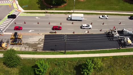 Aerial-view-of-new-asphalt-being-laid-on-city-street