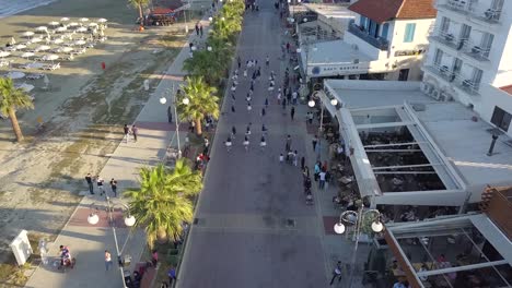 Overtake-Shot-Of-People-Walking-With-Costumes-On-Street-In-Parade