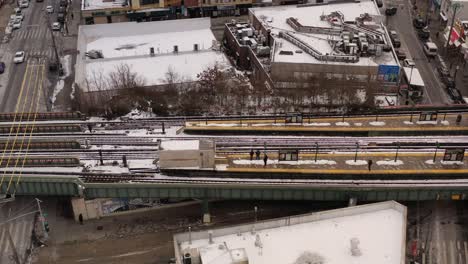 An-aerial-view-of-empty-train-tracks-on-a-morning-after-a-snowfall