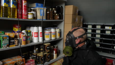 Prepper-wearing-a-gas-mask-in-a-fallout-shelter-with-a-sub-machine-gun