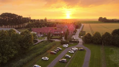 SUNSET-FROM-AN-AERIAL-VIEW-ON-A-BEAUTIFUL-CHALET-IN-LIEGE,-BELGIUM-4K-30FPS