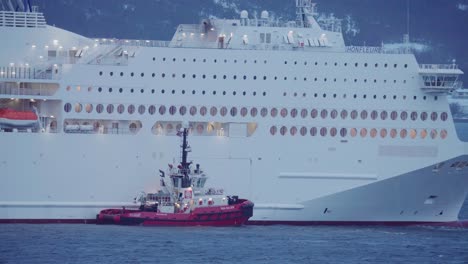 Tugboat-Floating-Beside-The-Luxury-Cruise-Ship