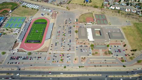 Drone-Aerial-View-Of-Large-High-School-Campus-Including-Football-Field,-Tennis-Courts,-And-Baseball-Field