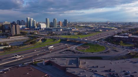 Scarborough,-Toronto,-Ontario-Highway-401-traffic-near-shopping-centre,-retail-stores,-commercial-and-industrial-buildings