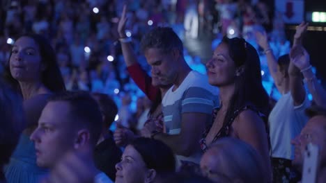 Mujer-De-Mediana-Edad-Aplaudiendo-En-Medio-De-Una-Gran-Multitud-En-Un-Concierto,-Pasándola-Genial