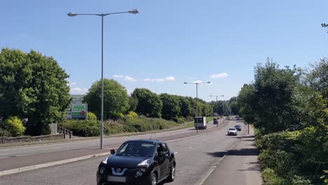 Steady-Traffic-on-Dual-Carriageway-Next-to-Asda-Store-4K