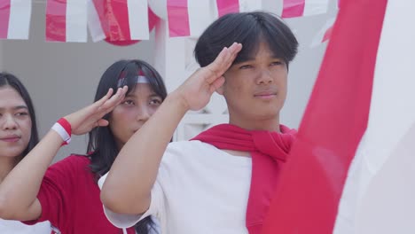 Young-Patriotic-People-Gesture-Saluting-To-Red-White-Flag-on-Indonesian-Independence-Day-Ceremony