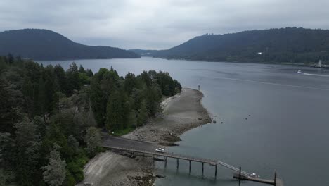 Sandy,-Rocky-Shore-and-Trees-on-the-Ocean-Coast-surrounded-by-mountains