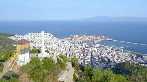 Kavala-City-Greece-Mountain-View,-Aerial-Point-of-Interest-Shot,-Cross-Monument-Foreground-Drone-Video