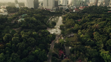 Aerial-view-of-lush-park-with-modern-Kuala-Lumpur-skyline