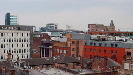 Rooftops,-chimneys-and-towers-in-city-of-Manchester,-UK,-on-cloudy-day