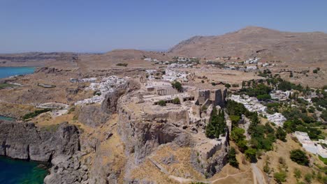 Aerial-view-of-Lindos’-Acropolis-perched-atop-a-peak-with-beautiful-views-of-Rhodes,-Greece