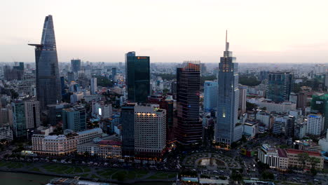 Iconic-Ho-Chi-Minh-City-skyline-buildings-overlooking-Saigon-river,-aerial