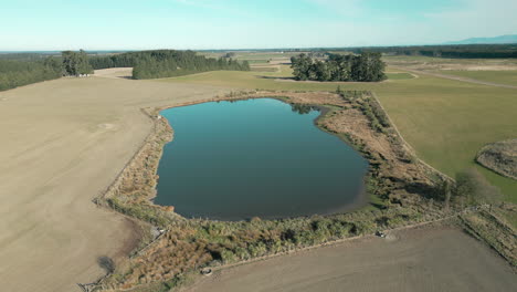 Lago-Sereno-En-Medio-De-Una-Granja-En-Canterbury,-Nueva-Zelanda