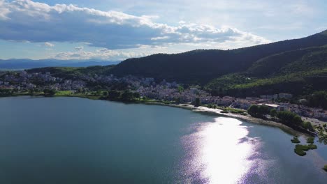 Lake-Orestiada-sun-reflexion,-Kastoria-Greece,-region-of-Macedonia,-aerial