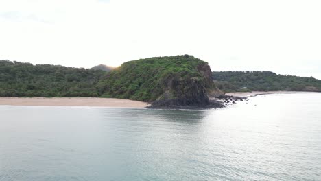 Aerial-coastline-view-of-Mohéli-or-Mwali,-part-of-the-Union-of-the-Comoros,-drone-approaching-green-rocky-cliff-at-day-time