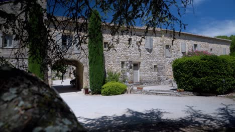 Slow-establishing-shot-of-a-stone-farmhouse-with-a-stone-archway