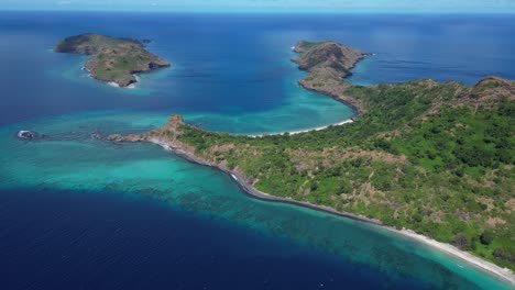 Aerial-seascape-of-Mohéli-or-Mwali,-part-of-the-Union-of-the-Comoros,-blue-ocean-indian-water-and-scenic-rock-formation-on-tropical-dreaming-island-paradise-travel-destination-in-Africa