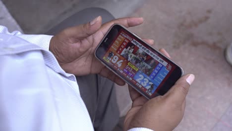 A-man-watching-online-news-on-his-mobile-phone,-Electronic-news-about-Indian-politics-and-Lok-Sabha-election-results