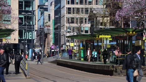 People-walk-by-tram-station-at-St