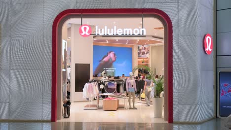 At-a-shopping-mall,-shoppers-are-seen-at-the-Canadian-sportswear-clothing-band,-Lululemon,-store-in-Hong-Kong